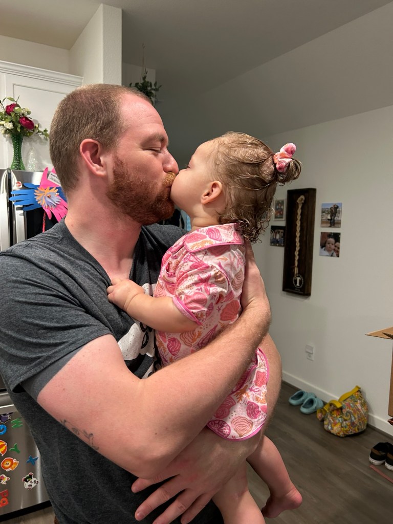 Toddler leaning in for a kiss that is every parent's dream.